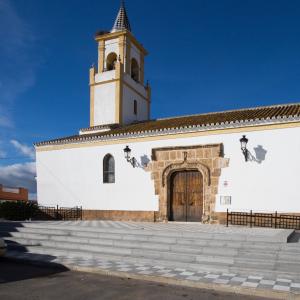 Alcolea del Río. Iglesia Parroquial de San Juan Bautista a lo lejos con un pony en primer plano